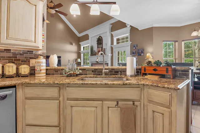 a view of a dining room with furniture a chandelier and wooden floor