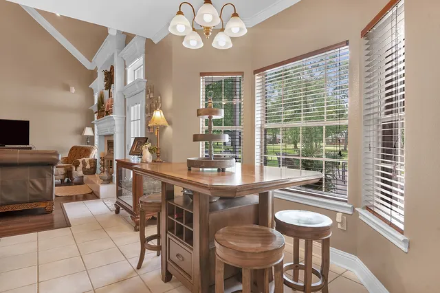 a living room with furniture fireplace and a large window