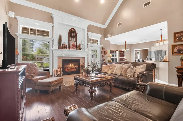 a living room with furniture a flat screen tv and a dining table