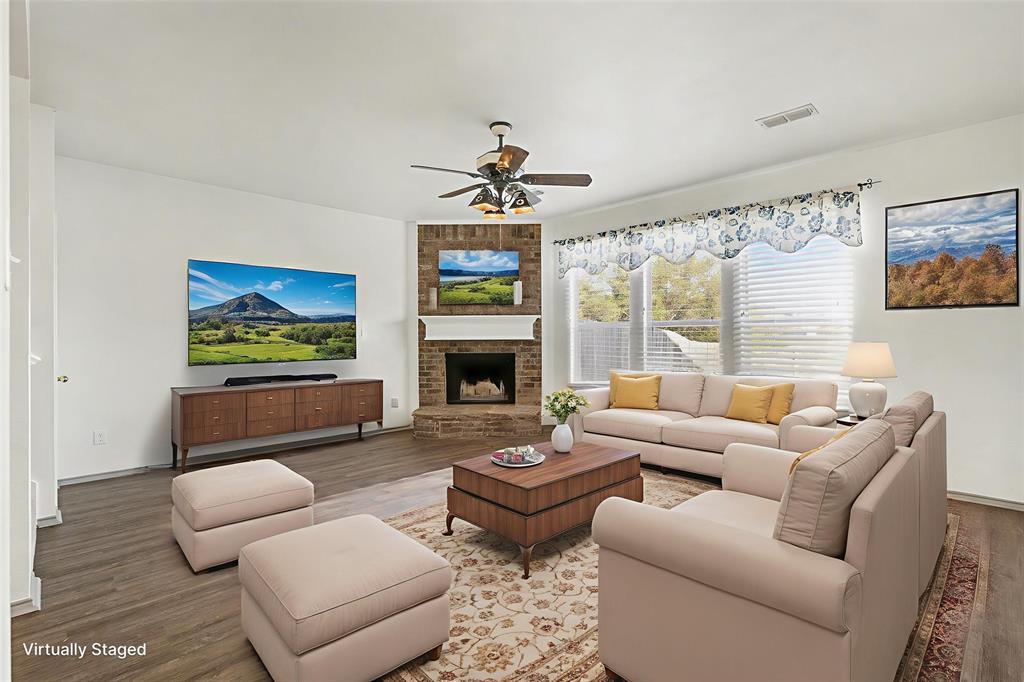 415 Hidden Ridge Drive Burleson, TX 76028 - Photo 12 of 38 a living room with furniture a fireplace and a flat screen tv