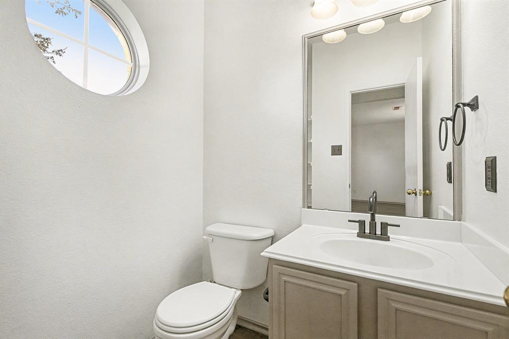 415 Hidden Ridge Drive Burleson, TX 76028 - Photo 15 of 38 a bathroom with a sink a toilet and a mirror