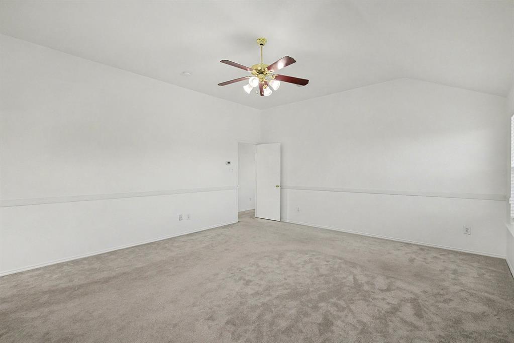 415 Hidden Ridge Drive Burleson, TX 76028 - Photo 21 of 38 a view of a chandelier fan in an empty room
