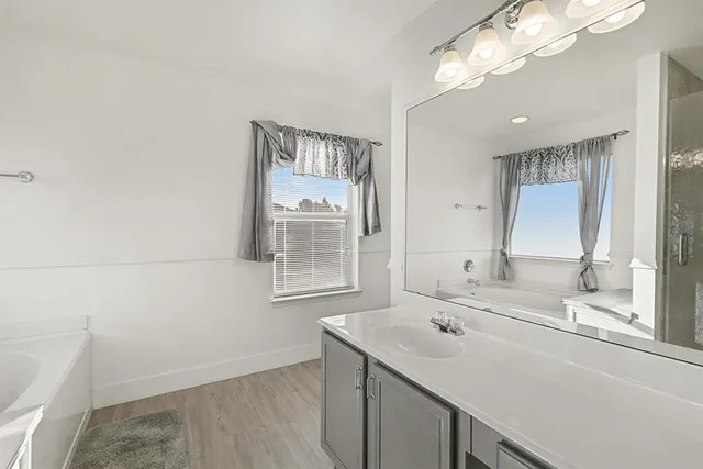 an empty room with a ceiling fan and window