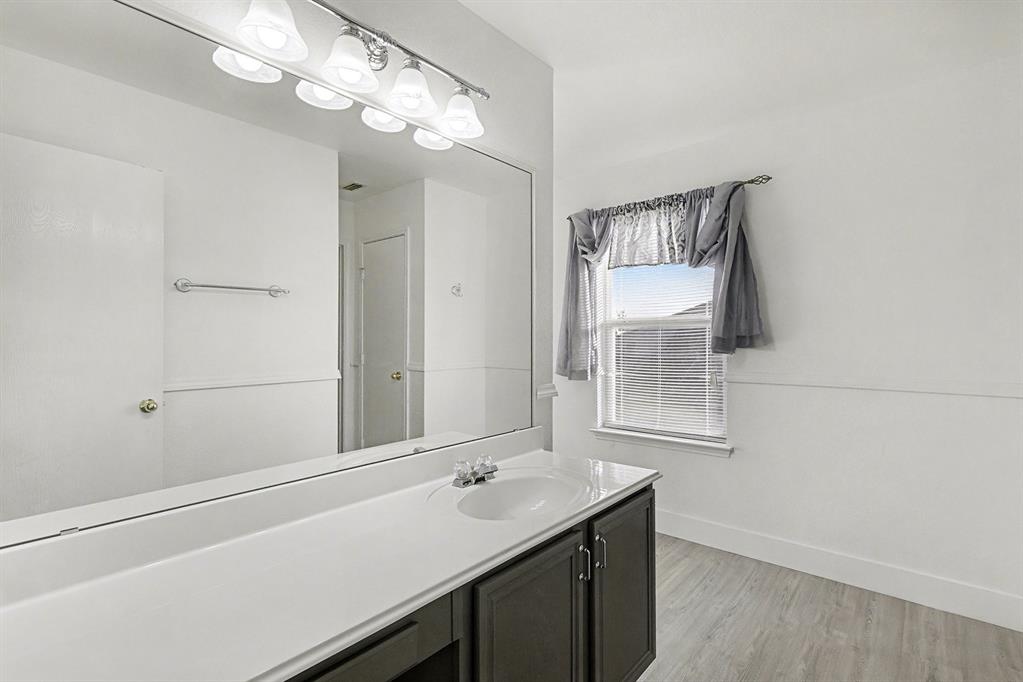 415 Hidden Ridge Drive Burleson, TX 76028 - Photo 23 of 38 a bathroom with a sink and a mirror
