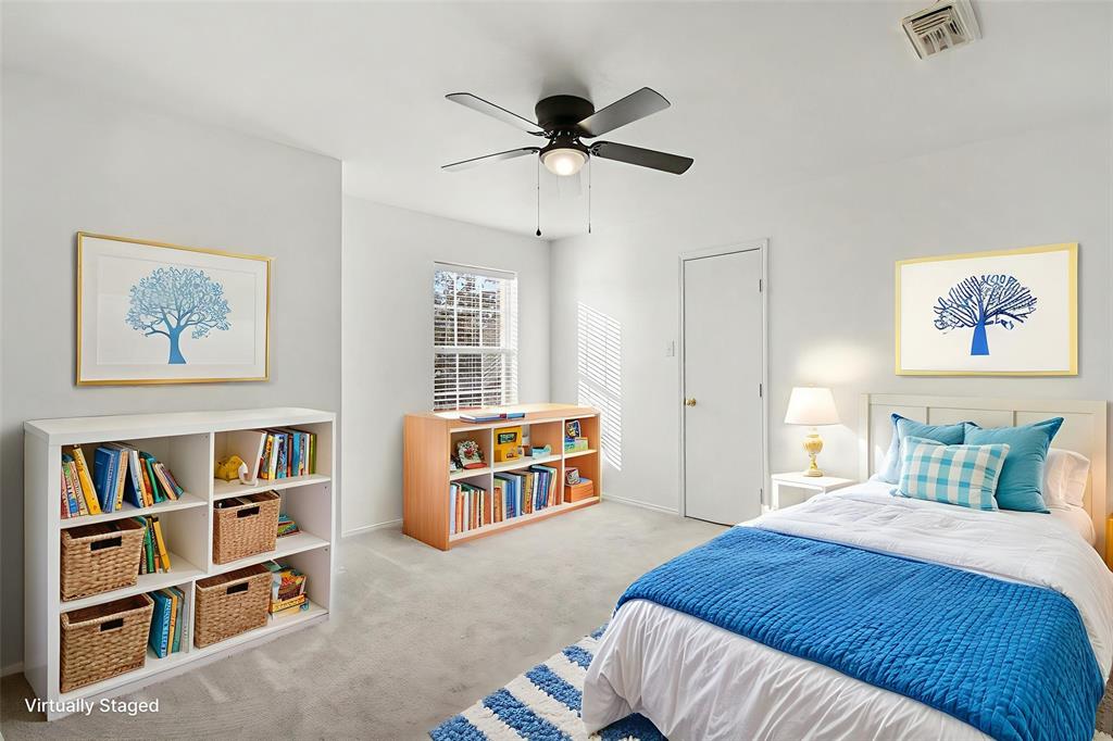 415 Hidden Ridge Drive Burleson, TX 76028 - Photo 25 of 38 a bedroom with furniture and a book shelf