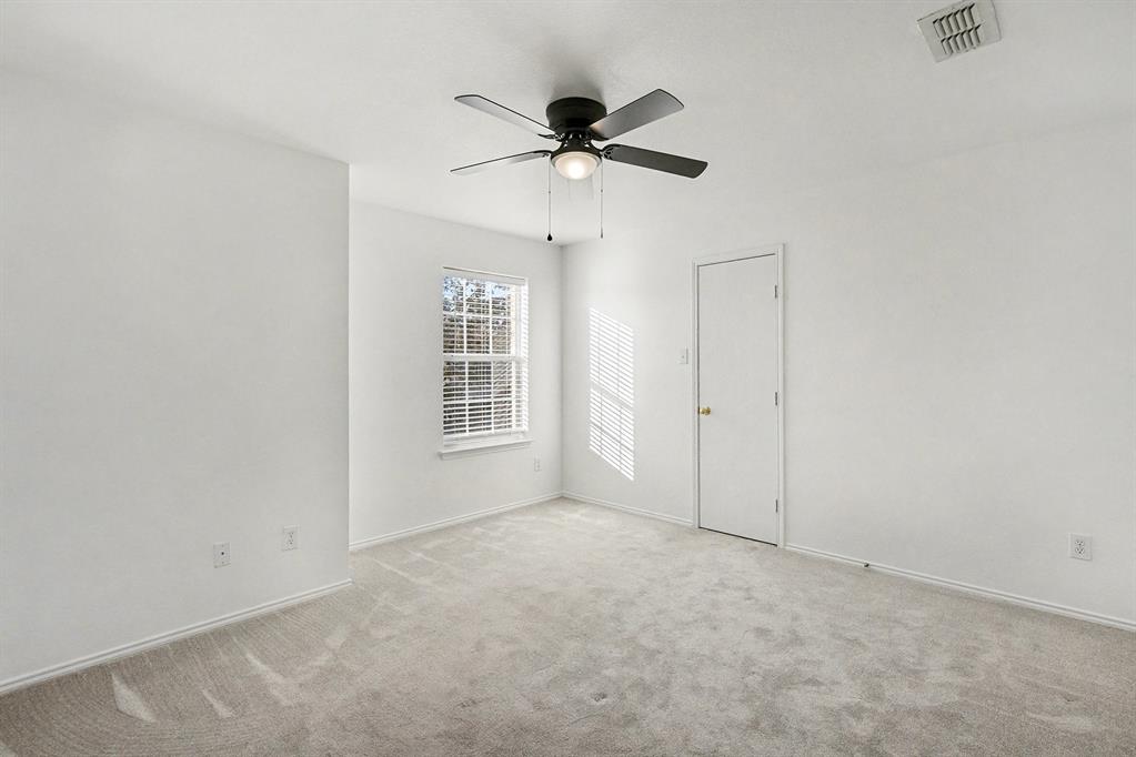 415 Hidden Ridge Drive Burleson, TX 76028 - Photo 26 of 38 an empty room with a ceiling fan and window