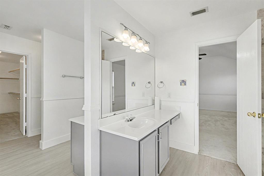 415 Hidden Ridge Drive Burleson, TX 76028 - Photo 28 of 38 a bathroom with a sink a light fixture and a glass door
