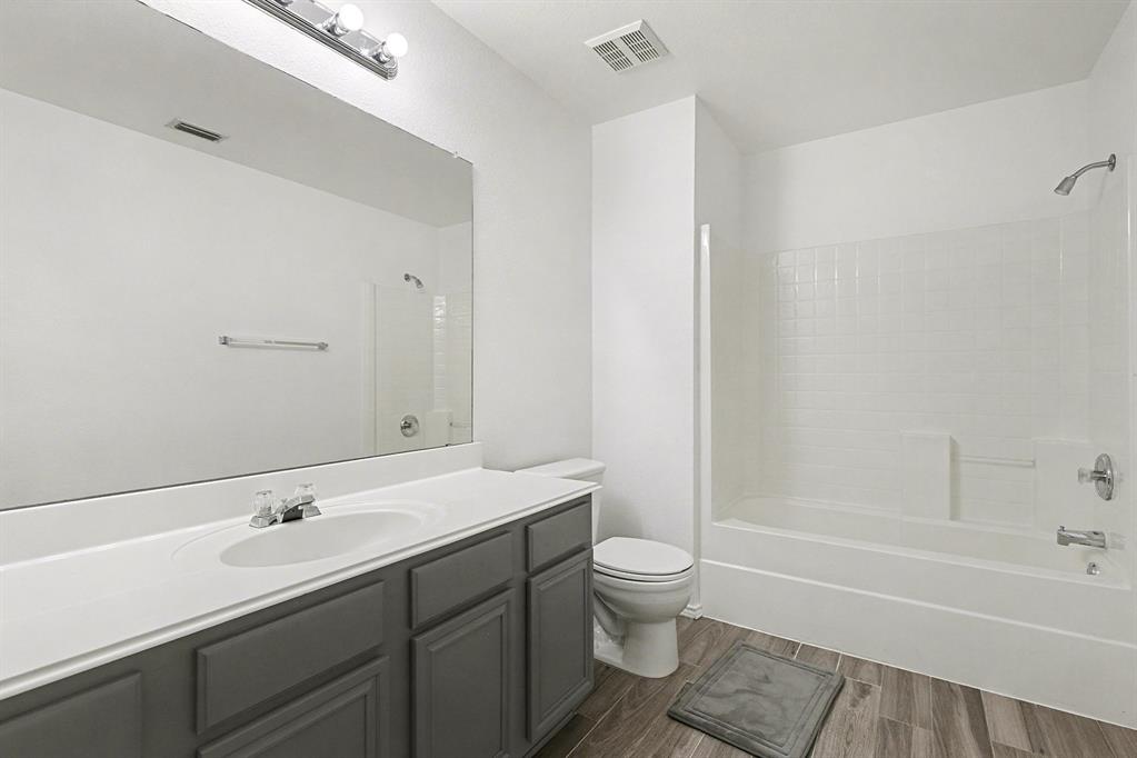 415 Hidden Ridge Drive Burleson, TX 76028 - Photo 31 of 38 a bathroom with a sink toilet and bathtub