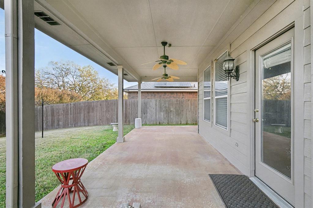 415 Hidden Ridge Drive Burleson, TX 76028 - Photo 33 of 38 a view of a porch with a table and chairs