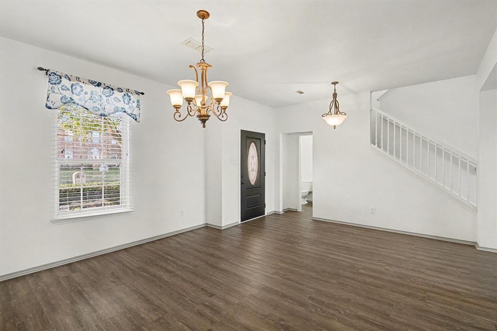 415 Hidden Ridge Drive Burleson, TX 76028 - Photo 5 of 38 a view of a room with wooden floor chandelier and windows