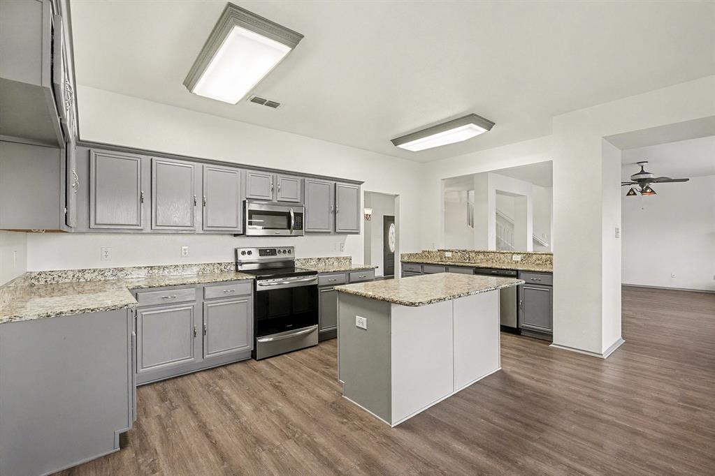 415 Hidden Ridge Drive Burleson, TX 76028 - Photo 10 of 38 a kitchen with appliances a sink and cabinets