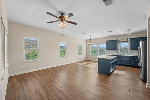 a view of kitchen with granite countertop cabinets and wooden floor