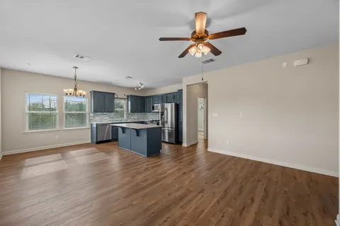 a view of kitchen with sink and refrigerator