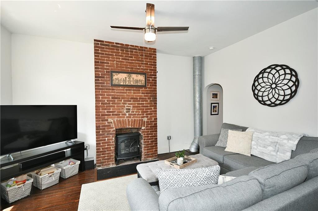 149 Home Street Pittsburgh, PA 15201 - Photo 11 of 14 a living room with furniture a flat screen tv and a fireplace
