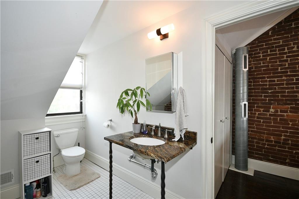 149 Home Street Pittsburgh, PA 15201 - Photo 13 of 14 a bathroom with a granite countertop sink and a toilet