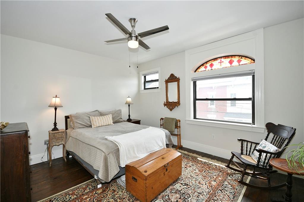 149 Home Street Pittsburgh, PA 15201 - Photo 2 of 14 a bedroom with a bed a computer on the desk and a window