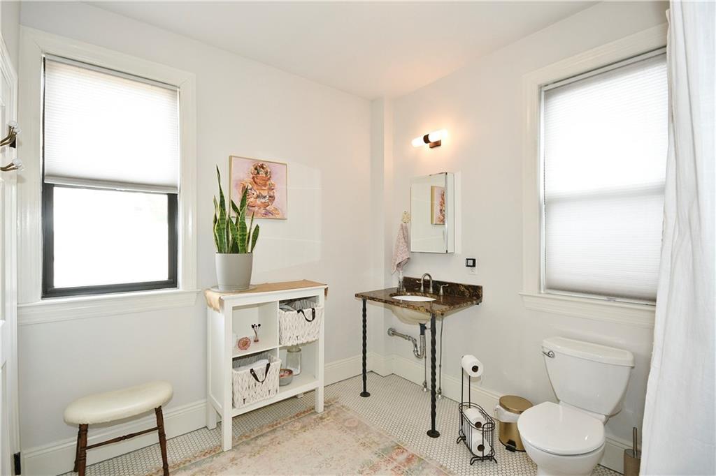 149 Home Street Pittsburgh, PA 15201 - Photo 4 of 14 a bathroom with a toilet a sink and a window