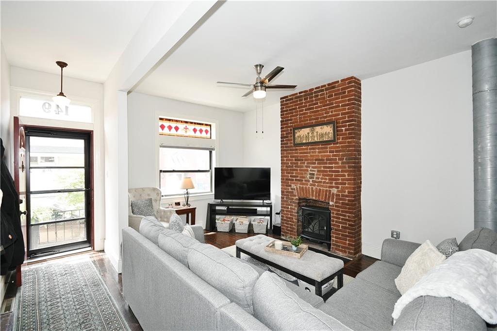 149 Home Street Pittsburgh, PA 15201 - Photo 10 of 14 a living room with furniture a flat screen tv and a fireplace