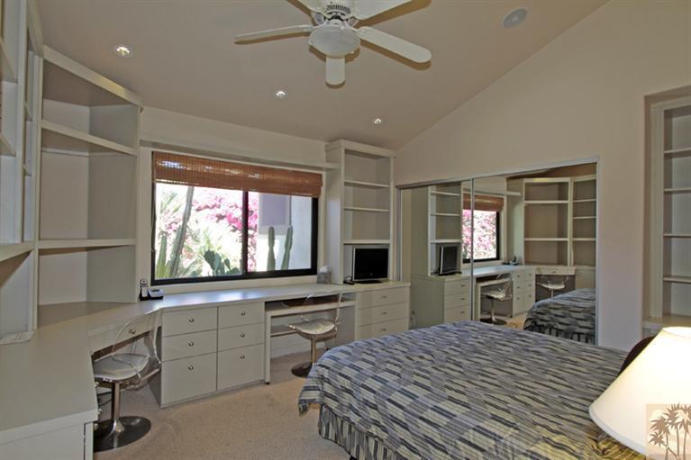 320 Red River Road Palm Desert, CA 92211 - Photo 19 of 31 a bedroom with furniture window and flat screen tv
