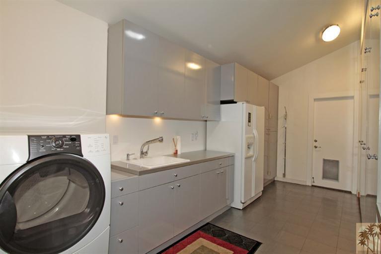 320 Red River Road Palm Desert, CA 92211 - Photo 25 of 31 a kitchen with a sink cabinets and a washer dryer