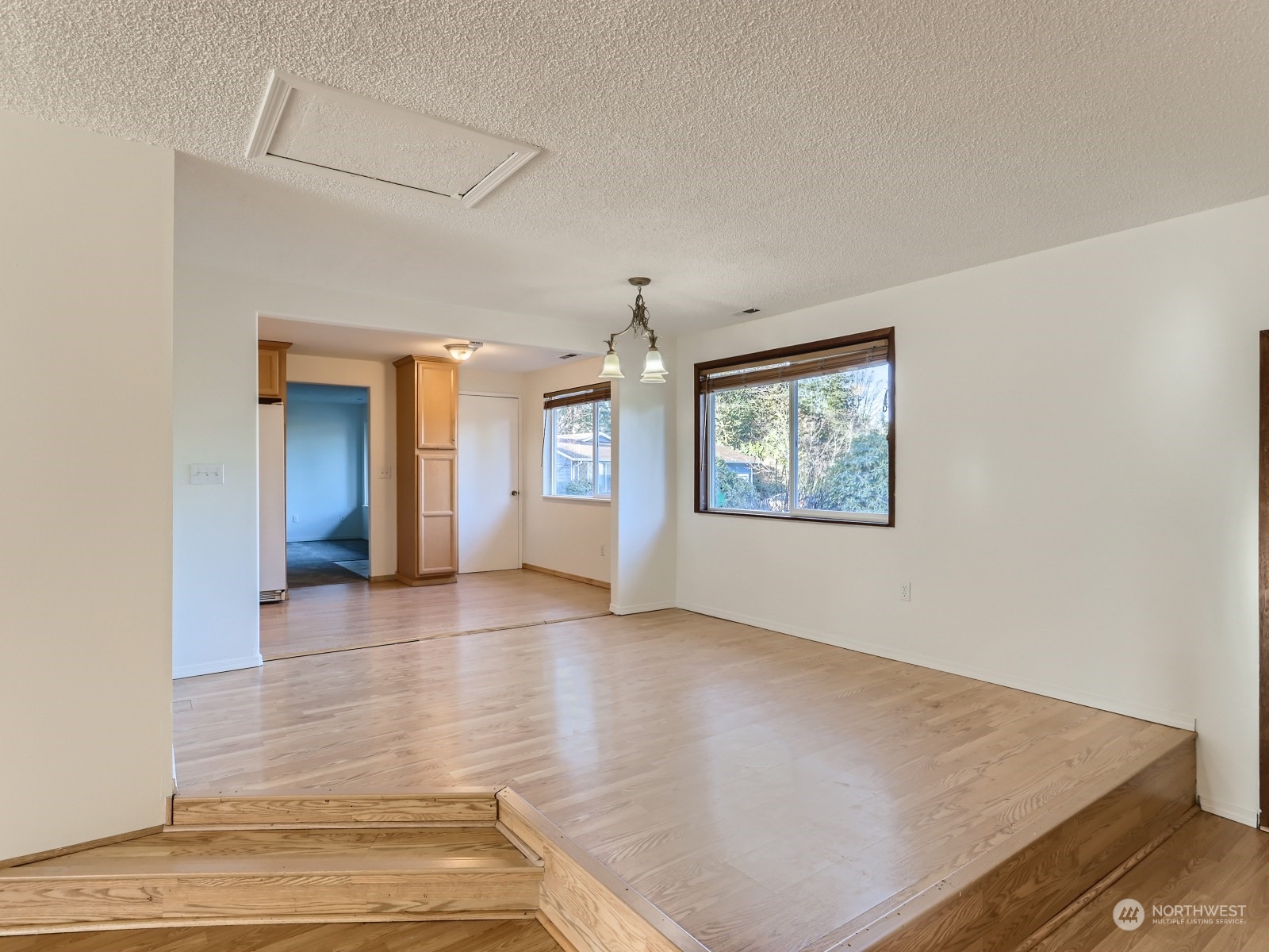 22031 7th Avenue West Bothell, WA 98021 - Photo 11 of 30 an empty room with wooden floor and windows