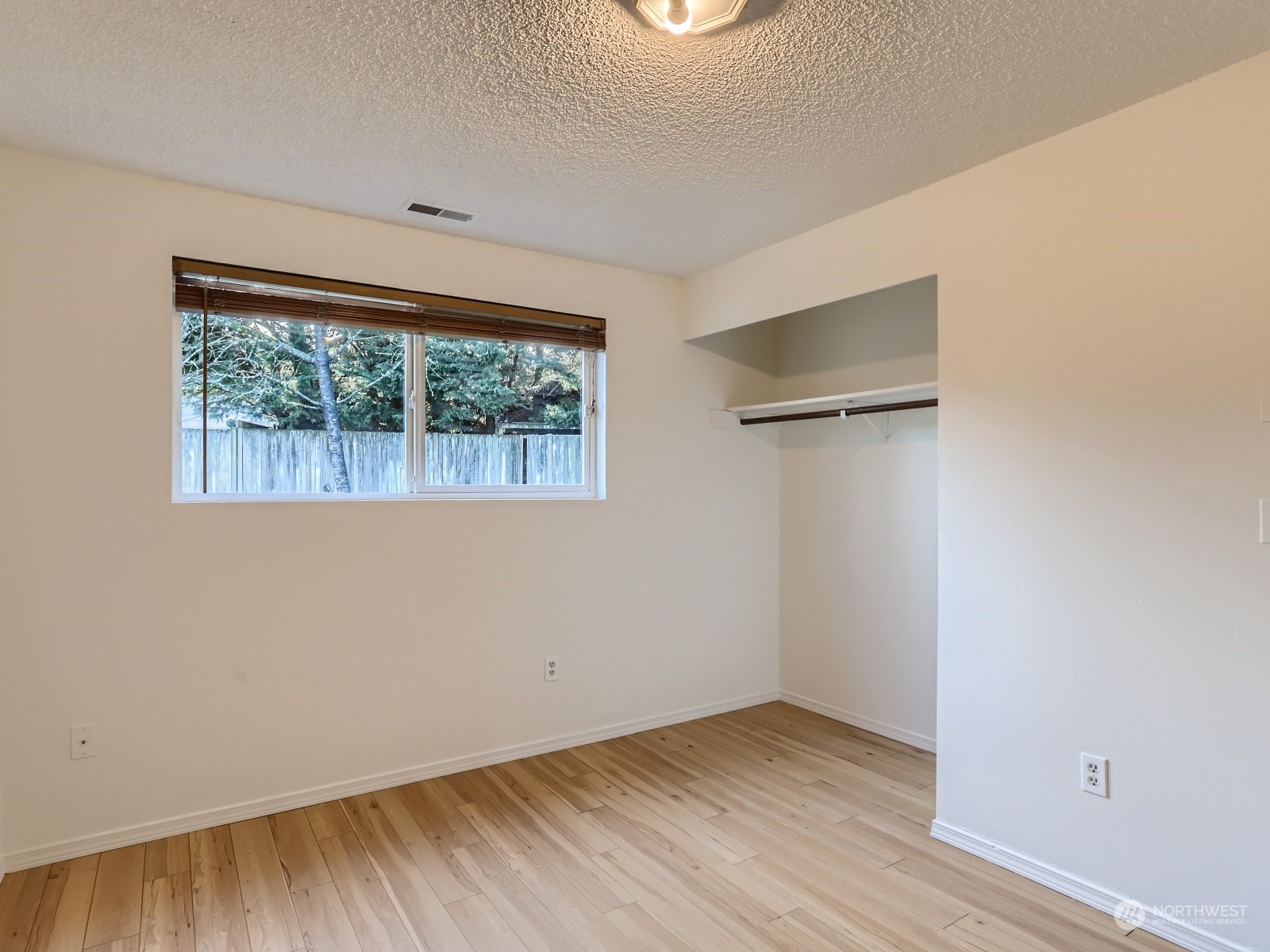 22031 7th Avenue West Bothell, WA 98021 - Photo 20 of 30 an empty room with wooden floor and windows