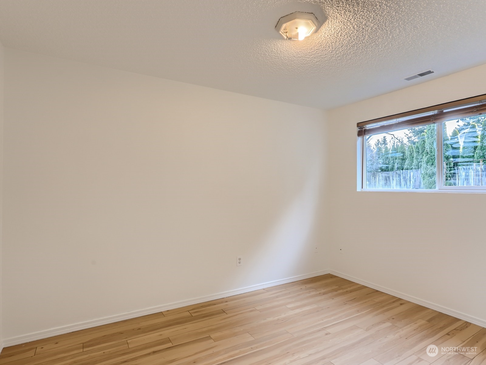22031 7th Avenue West Bothell, WA 98021 - Photo 21 of 30 an empty room with wooden floor and windows