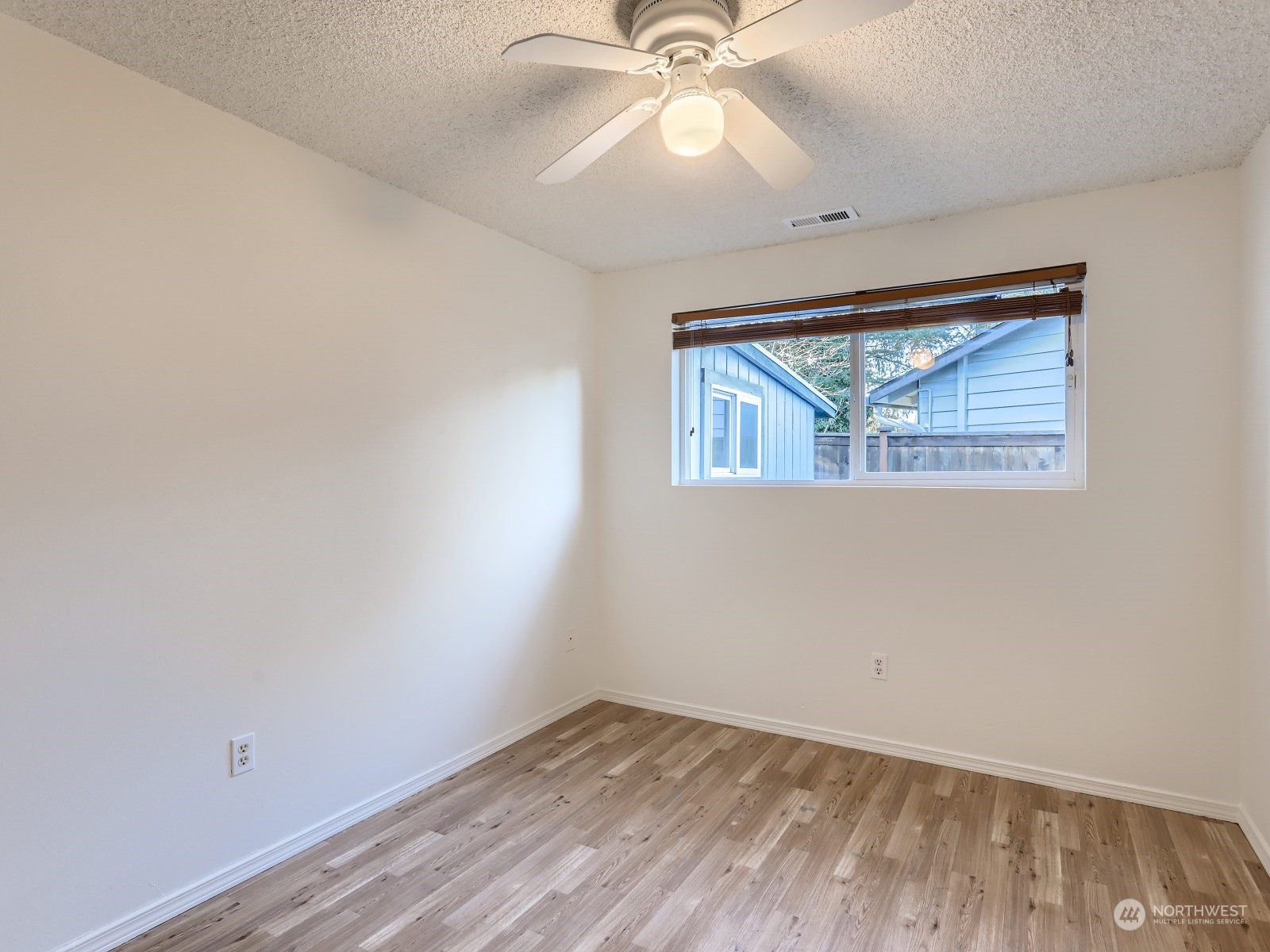 22031 7th Avenue West Bothell, WA 98021 - Photo 22 of 30 an empty room with a window and a fan