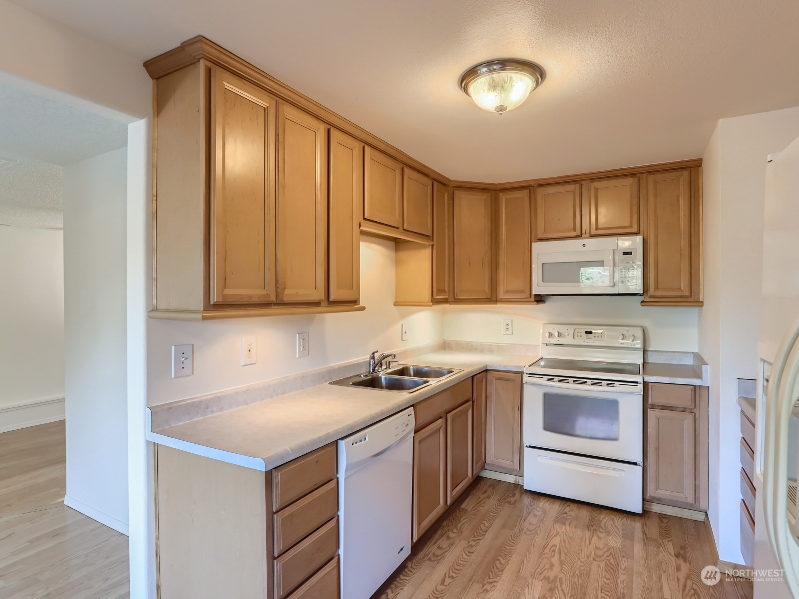 22031 7th Avenue West Bothell, WA 98021 - Photo 7 of 30 a kitchen with stainless steel appliances granite countertop a stove a sink dishwasher and a refrigerator