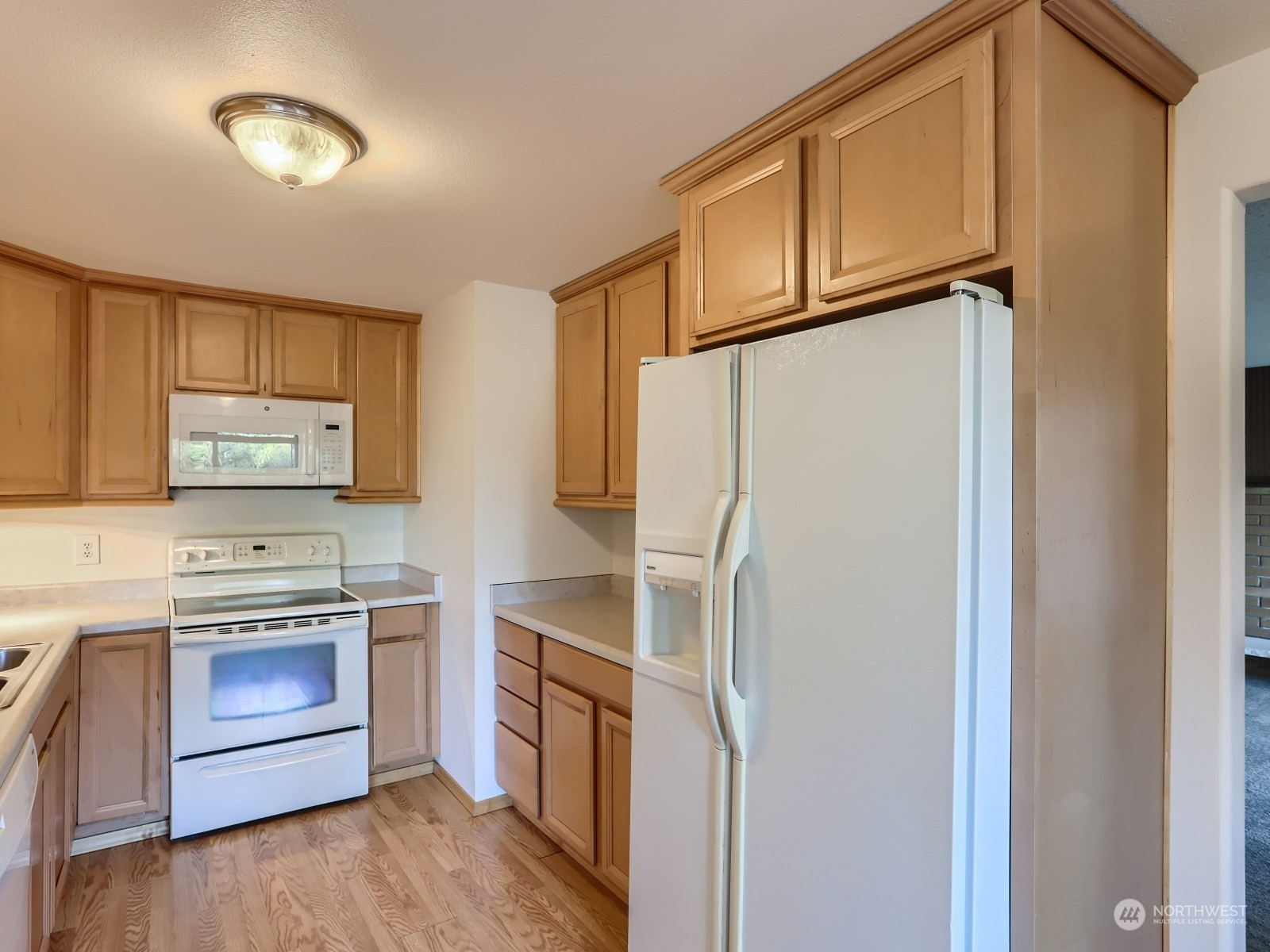 22031 7th Avenue West Bothell, WA 98021 - Photo 8 of 30 a kitchen with a refrigerator sink stove and cabinets