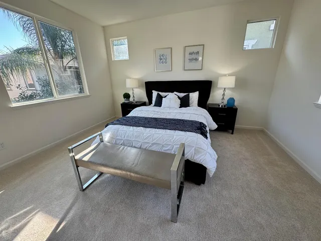 a bedroom with a bed and a window