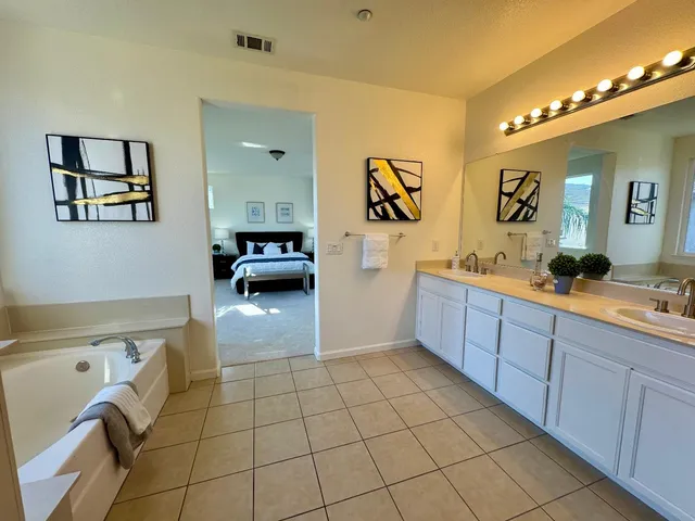 a bedroom with a bed and a painting on the wall