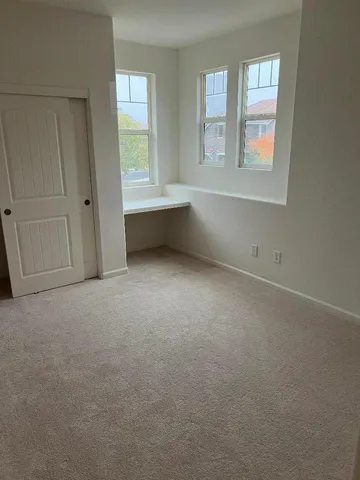 a view of a pathway of a house with wooden fence