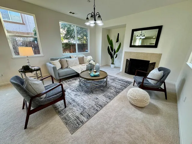 a living room with furniture a window and a fireplace