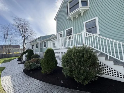 a front view of a house with a garden