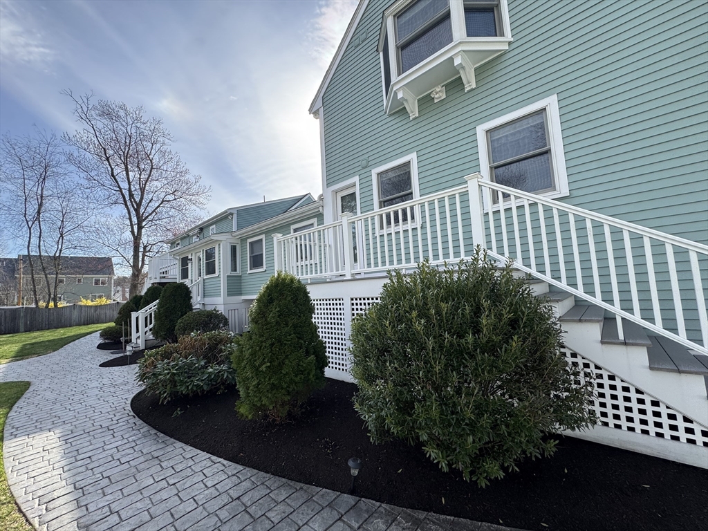 97 Hartwell Road Bedford, MA 01730 - Photo 32 of 42 a front view of a house with a garden