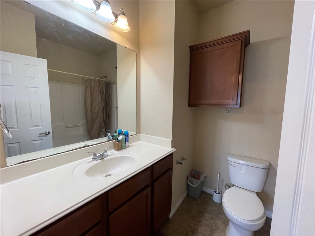 1198 Jones-Butler Road, Unit 2706 College Station, TX 77840 - Photo 7 of 17 a bathroom with a sink a toilet a mirror and vanity