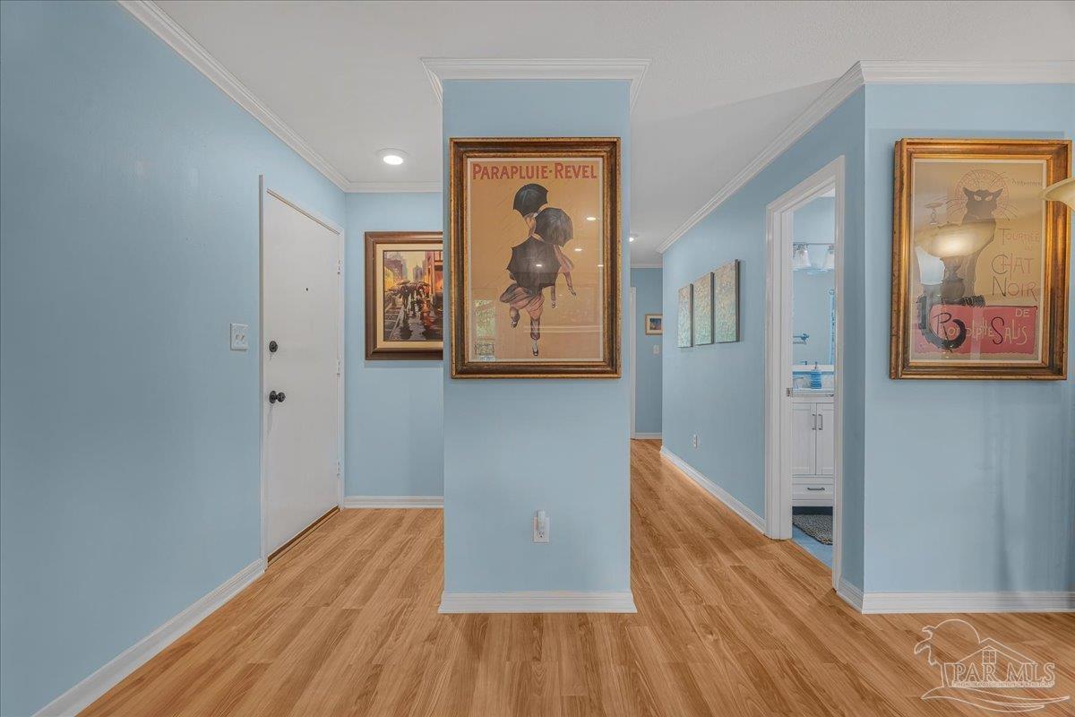 4831 East Olive Road, Unit 1D Pensacola, FL 32514 - Photo 27 of 36 a view of a hallway with wooden floor and a bathroom