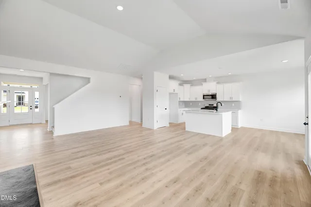 a kitchen with white cabinets a sink and appliances