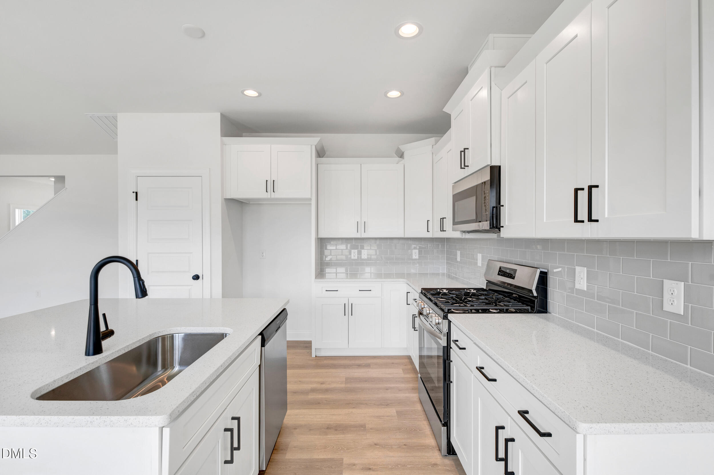 467 Ravensworth Drive Garner, NC 27529 - Photo 25 of 27 a kitchen with white cabinets a sink and appliances