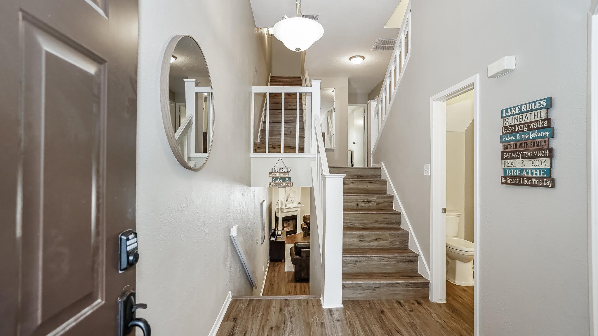 129 Capetown Conroe, TX 77356 - Photo 2 of 35 As soon as you enter this 4 story home you are greeted by laminate wood floors that flow throughout the living spaces.