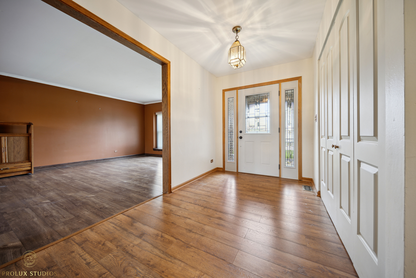 848 Willowbrook Drive Wheeling, IL 60090 - Photo 2 of 23 a view of a hallway with wooden floor and chandelier