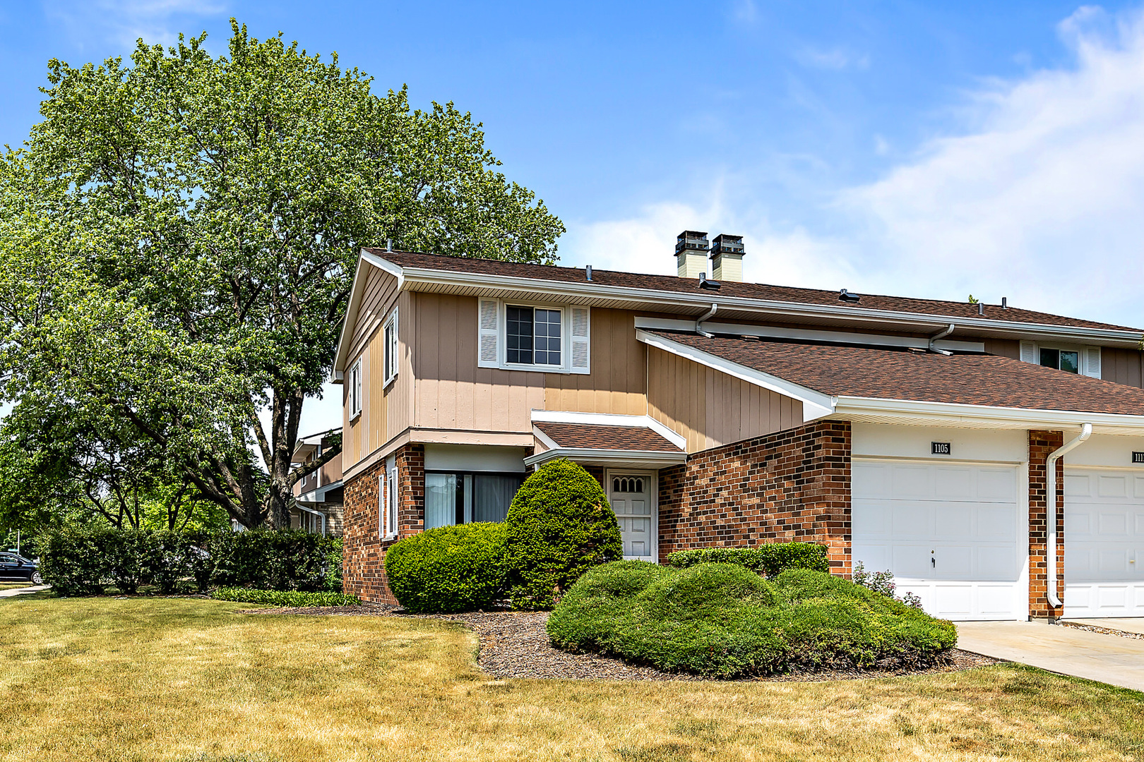1105 Rhodes Court Wheaton, IL 60189 - Photo 1 of 22 a front view of a house with a yard