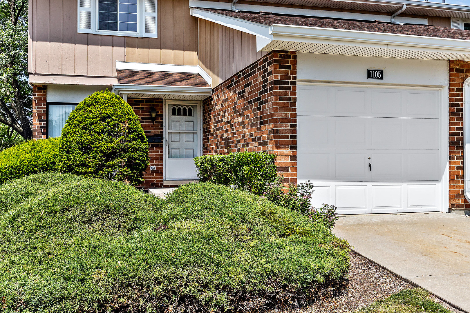 1105 Rhodes Court Wheaton, IL 60189 - Photo 2 of 22 a front view of a house with a yard
