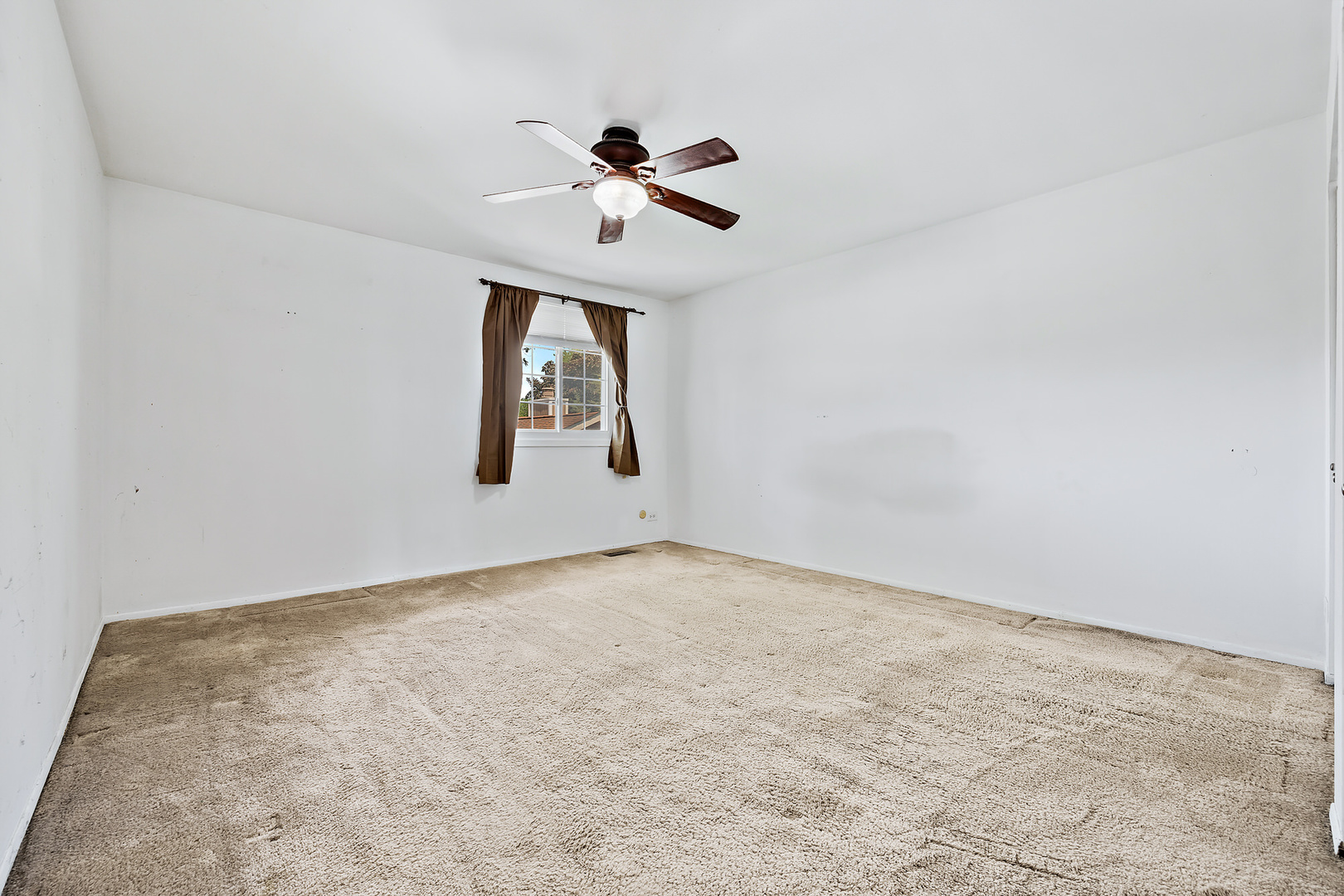 1105 Rhodes Court Wheaton, IL 60189 - Photo 8 of 22 an empty room with windows and fan