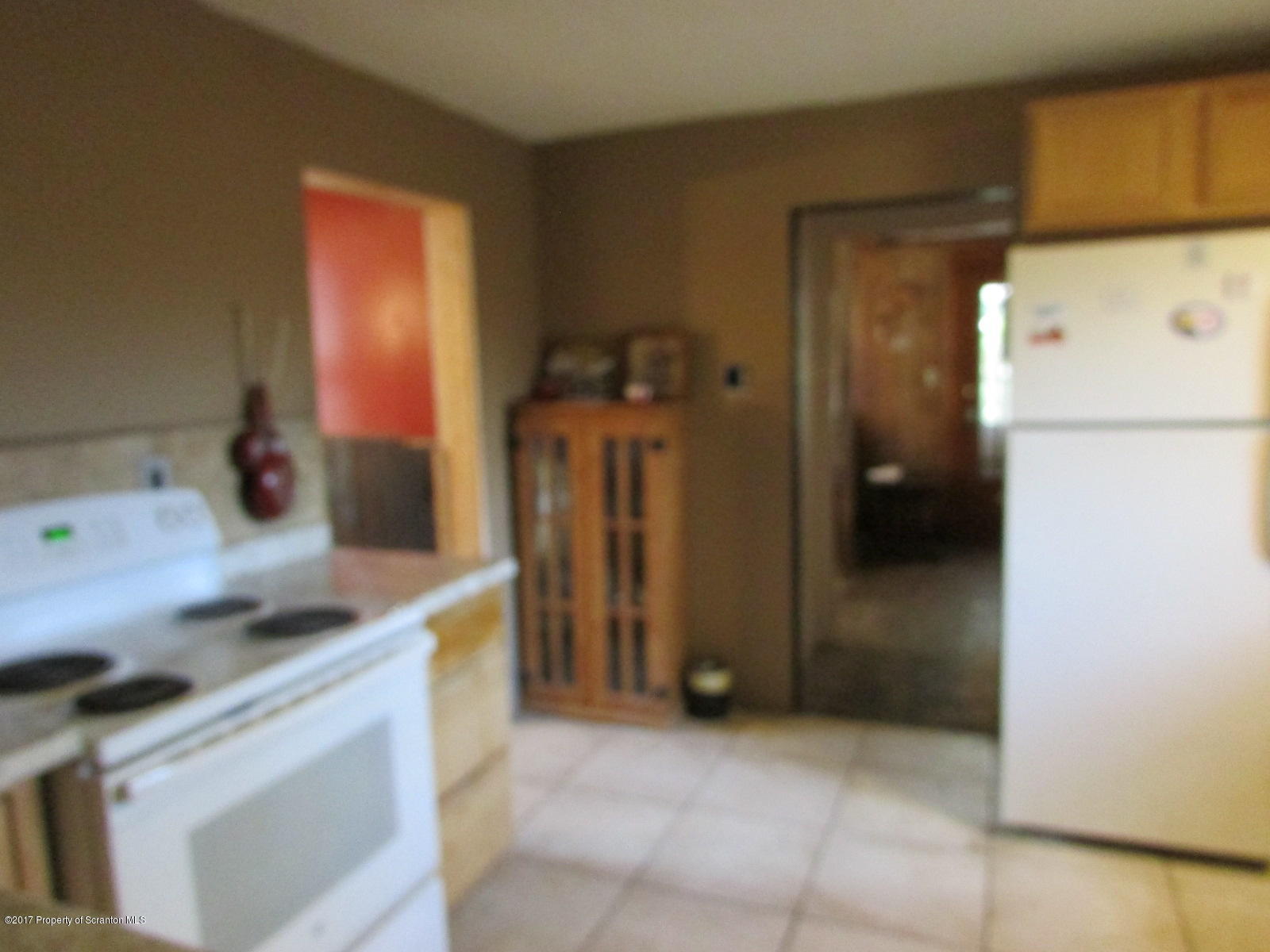 228 Ridge Road South Montrose, PA 18801 - Photo 8 of 20 a kitchen with a refrigerator and a stove