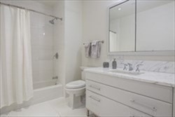 22 Liberty Drive, Unit 5L Boston, MA 02210 - Photo 6 of 17 a bathroom with a granite countertop sink toilet and shower