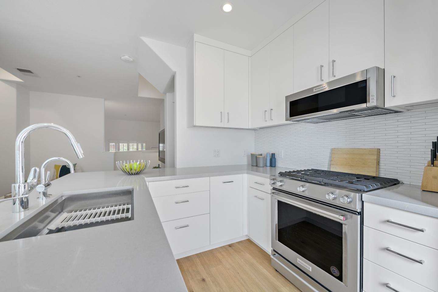 135 Pacchetti Way Mountain View, CA 94040 - Photo 7 of 27 a kitchen with granite countertop a stove top oven a sink and a microwave
