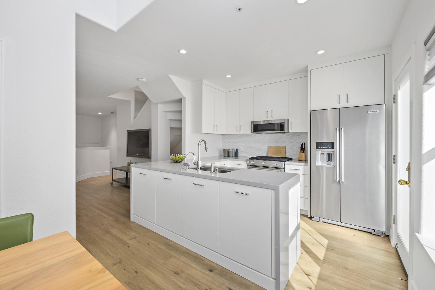 135 Pacchetti Way Mountain View, CA 94040 - Photo 10 of 27 a kitchen with white cabinets and stainless steel appliances
