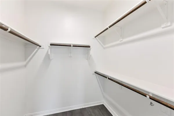 a view of closet with wooden floor